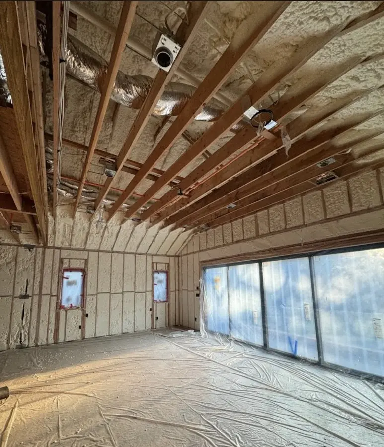 Interior walls and ceiling insulated with spray foam during new construction in Lenoir